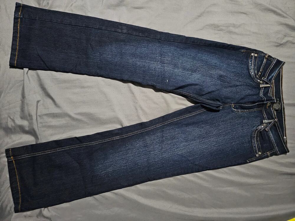 Dark wash denim jeans with contrast stitching and cuffed hem